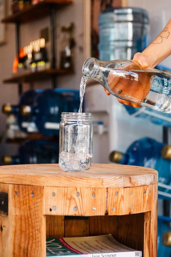 Pouring a Hi Vibe Water bottle during a client content shoot